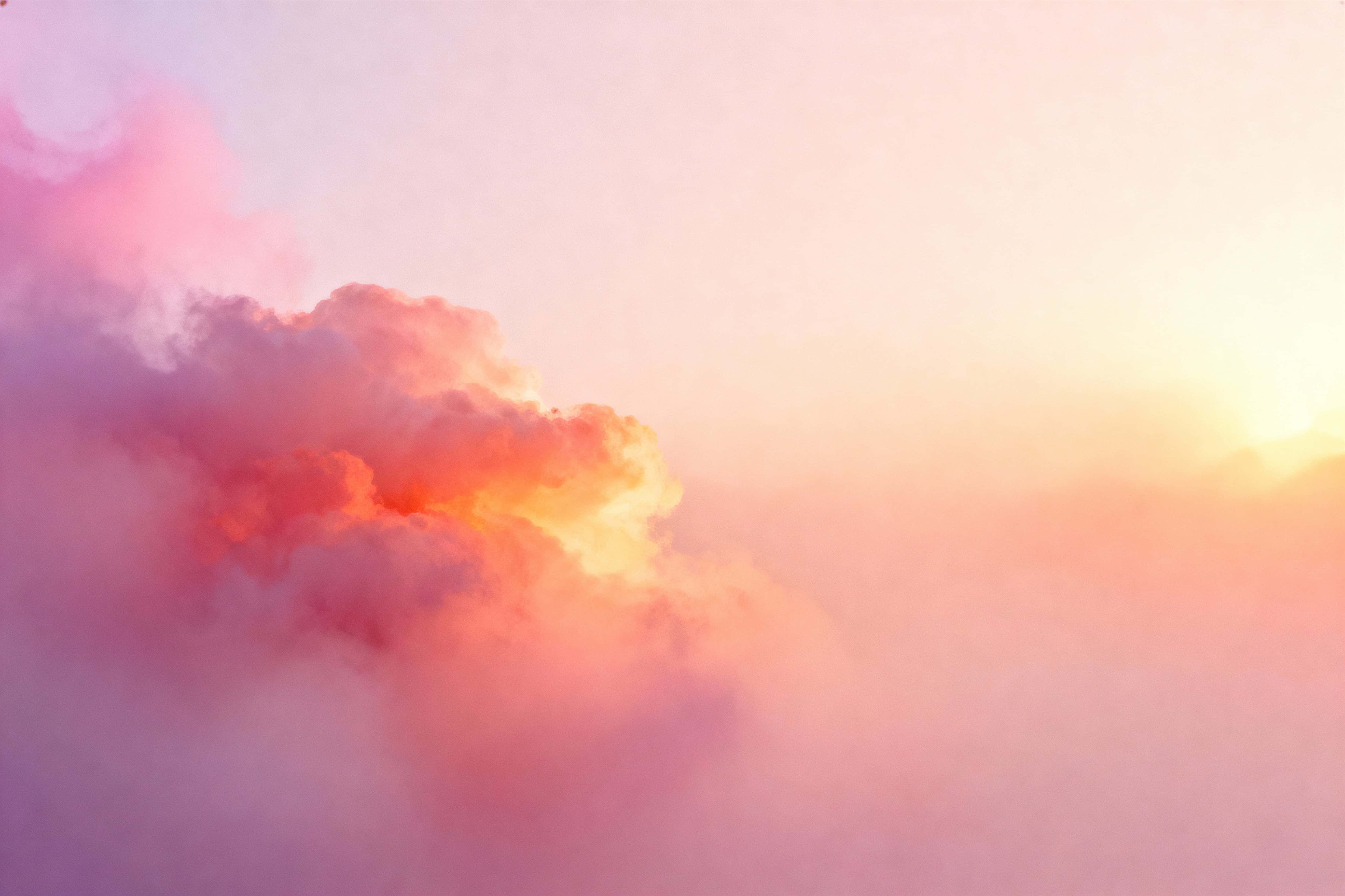 Smooth, non-figurative warm gradient drifting diagonally from lower-left to upper-right with a soft coral-amber focal zone off-center and muted lavender edges, cropped to a 3:2 frame.