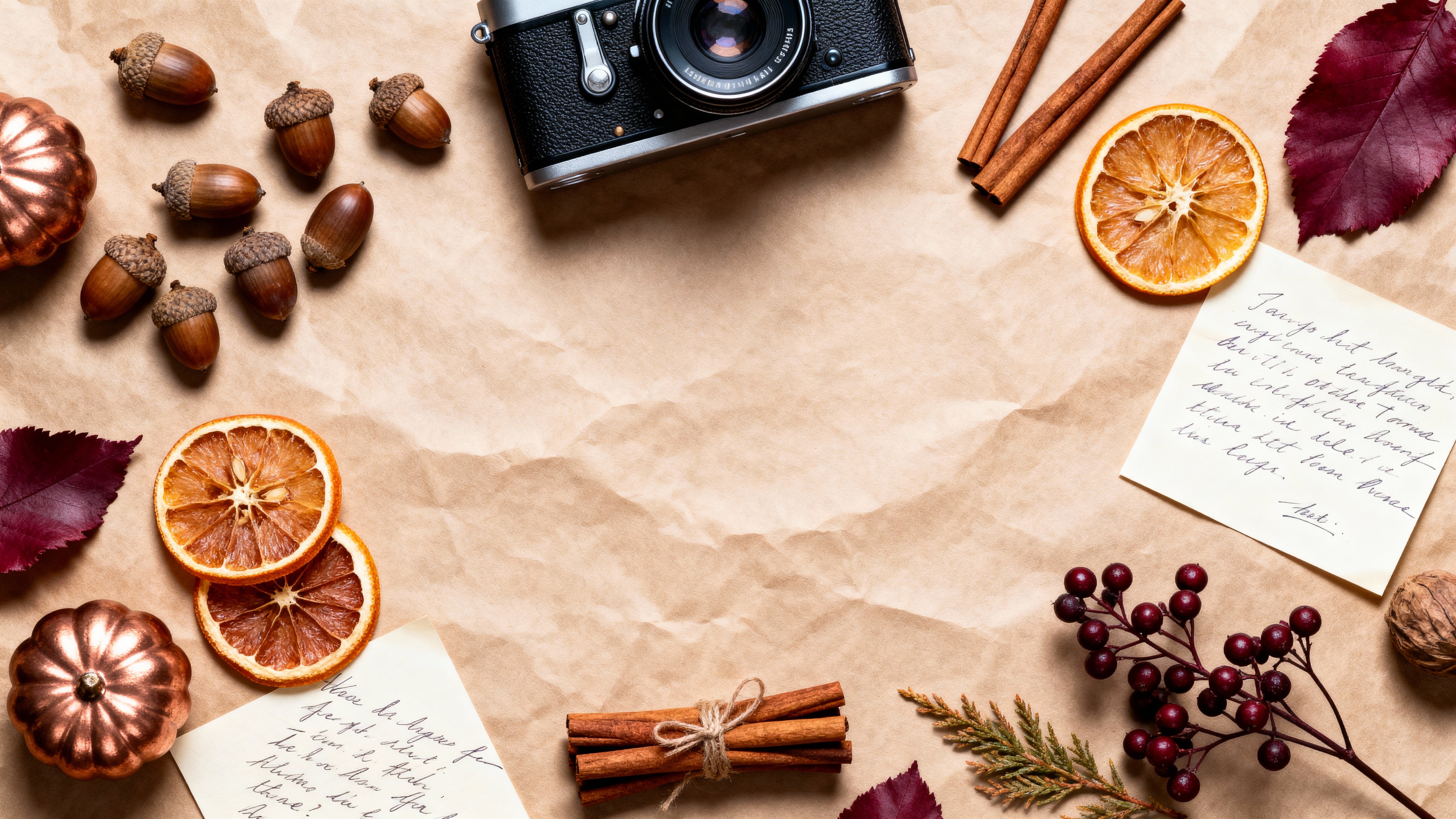 A top-down symmetrical flat-lay of autumn treasures—acorns, dried orange slices, cinnamon sticks, handwritten notes and a vintage camera—on a parchment-toned background with even focus, preserved textures, warm neutrals and copper and muted