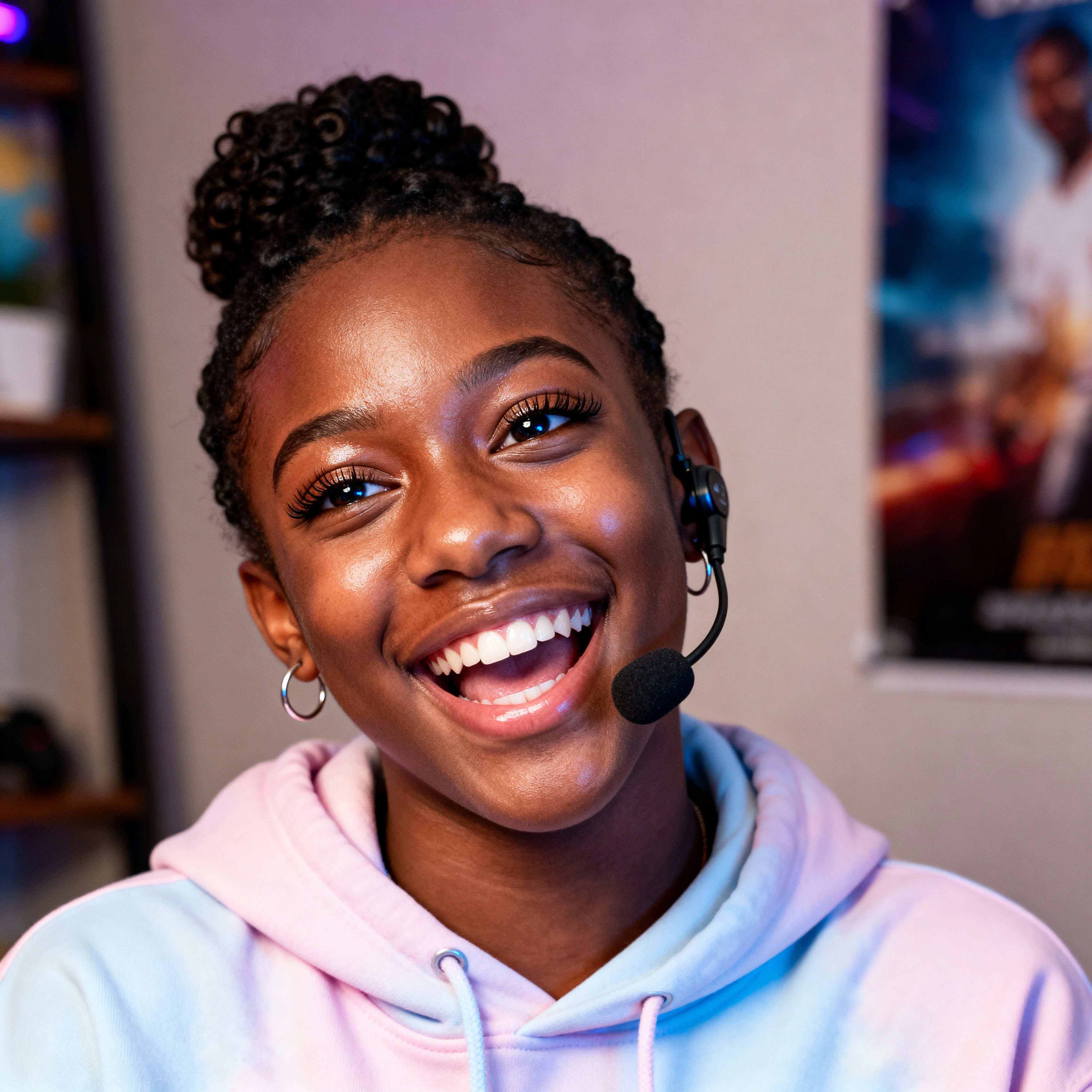 Headshot of a 19-year-old Black Southern gamer-student mid-laugh in a pastel-lavender hoodie, warm deep-brown skin with gold highlights, coil hair pinned up, muted-teal background and soft beige shelves, all lit with a soft even glow.