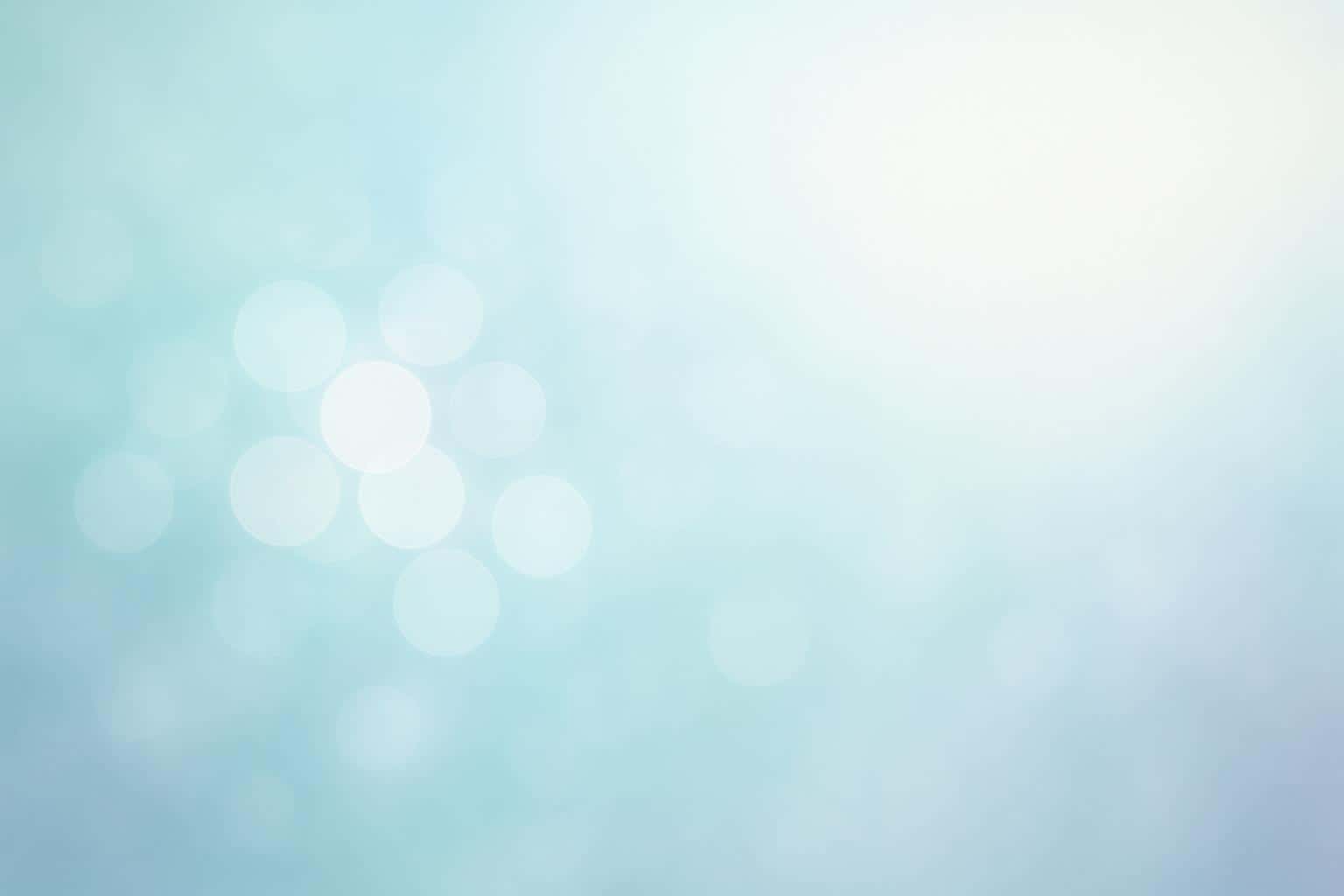 Dreamy 3:2 abstract bokeh field with overlapping frosted-glass circles clustered center-left, pale sky-blue and mint gradients, soft dawn illumination, and calm negative space.