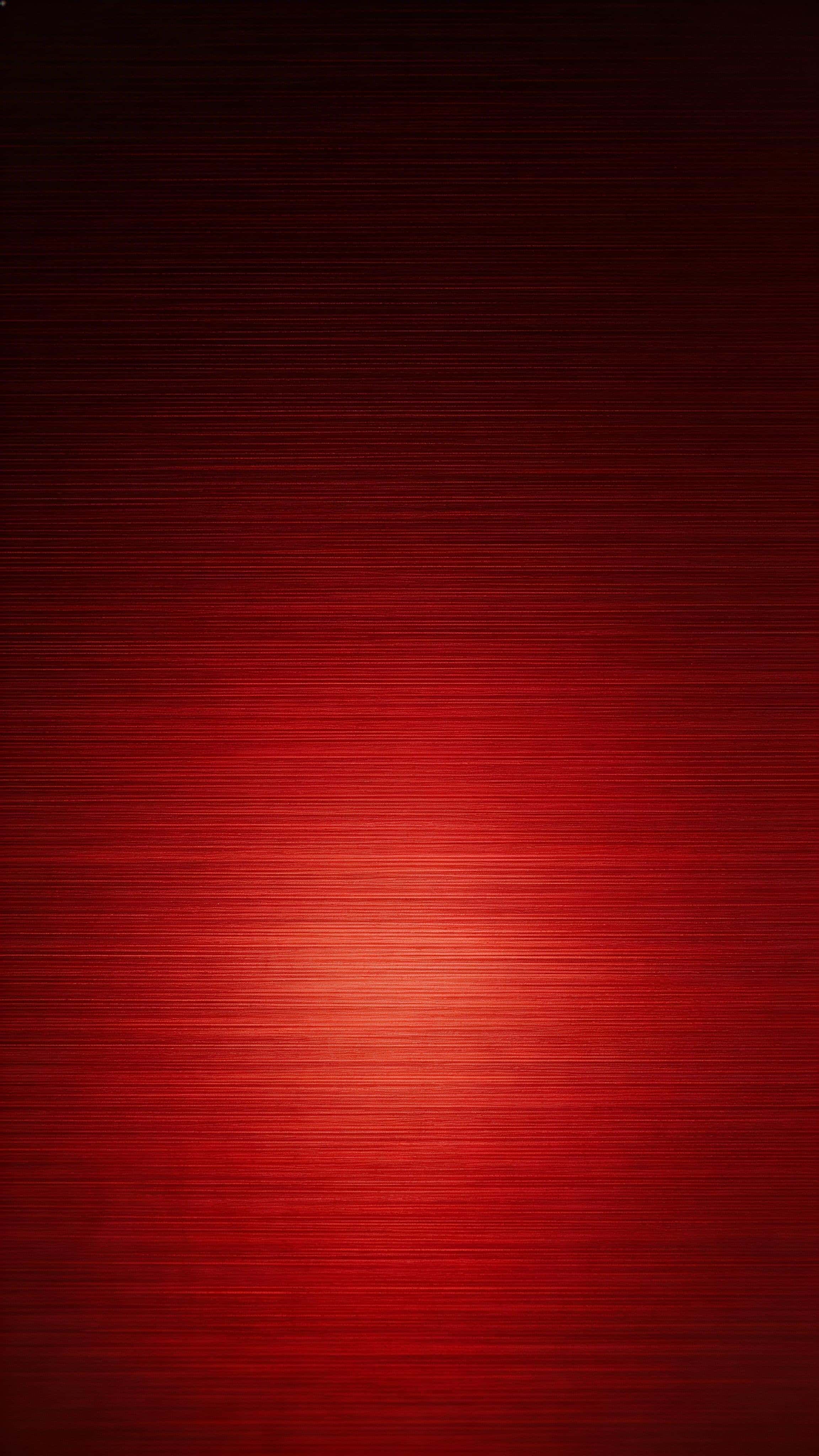 A 9:16 portrait wallpaper of premium brushed red metal with a clean horizontal grain and a bright lower-middle sheen fading into a calm, near-black top third.