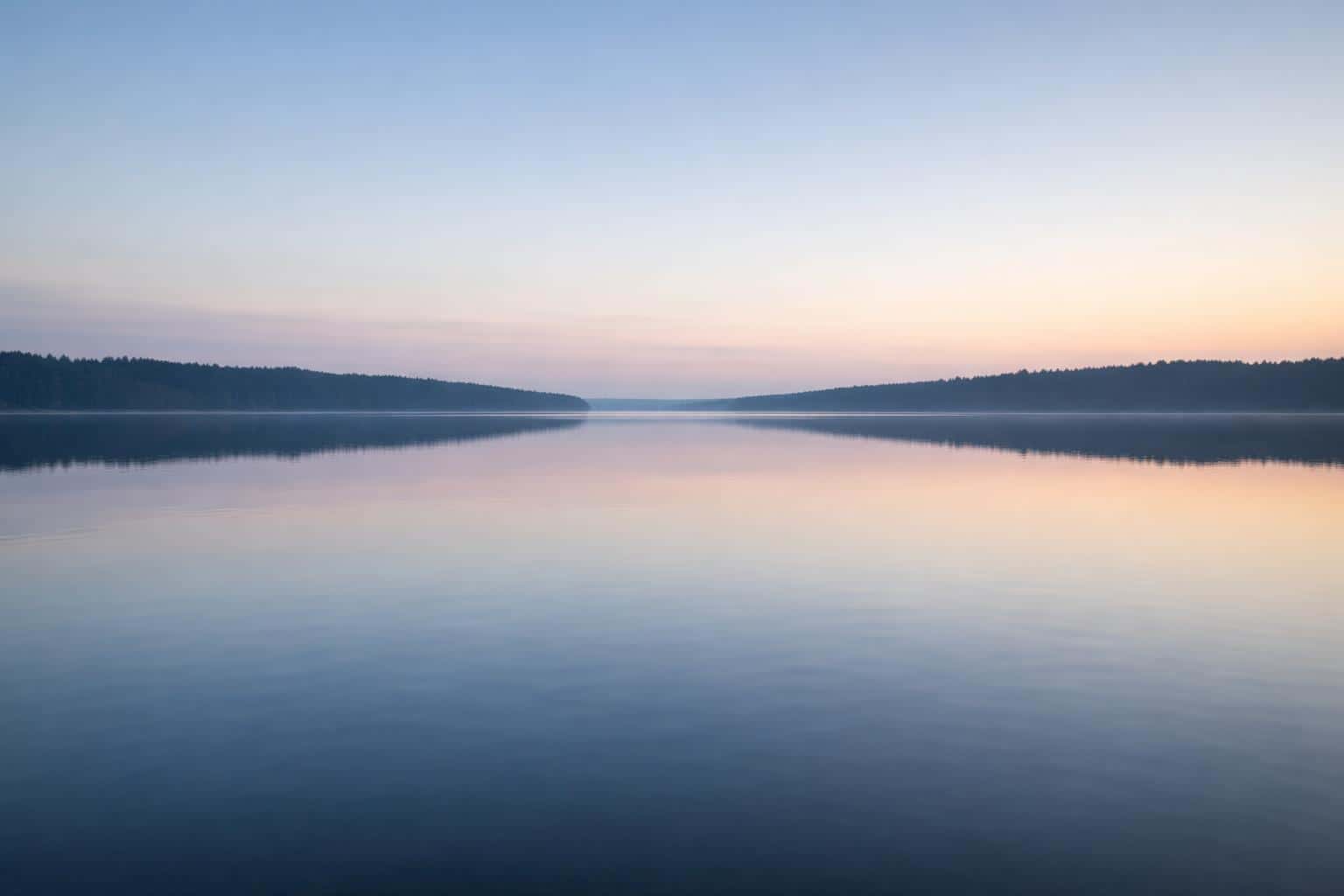 Calm lake landscape photography with a perfectly centered horizon and 3:2 aspect framing for wallpaper or poster use, rendered as a serene, minimal composition.