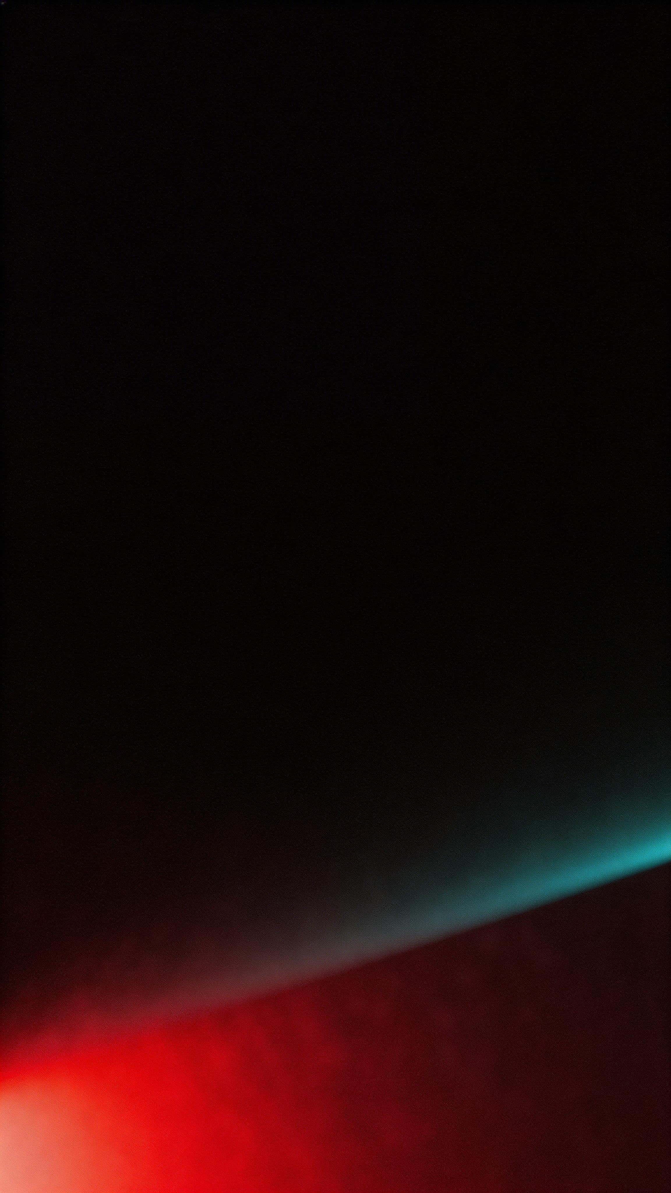A 9:16 vertical wallpaper where a deep crimson glow rises diagonally from the lower third into near-black, fading through wine and maroon with a cyan-teal fringe, soft bloom, thin haze, and fine film grain for a premium, spacious feel.