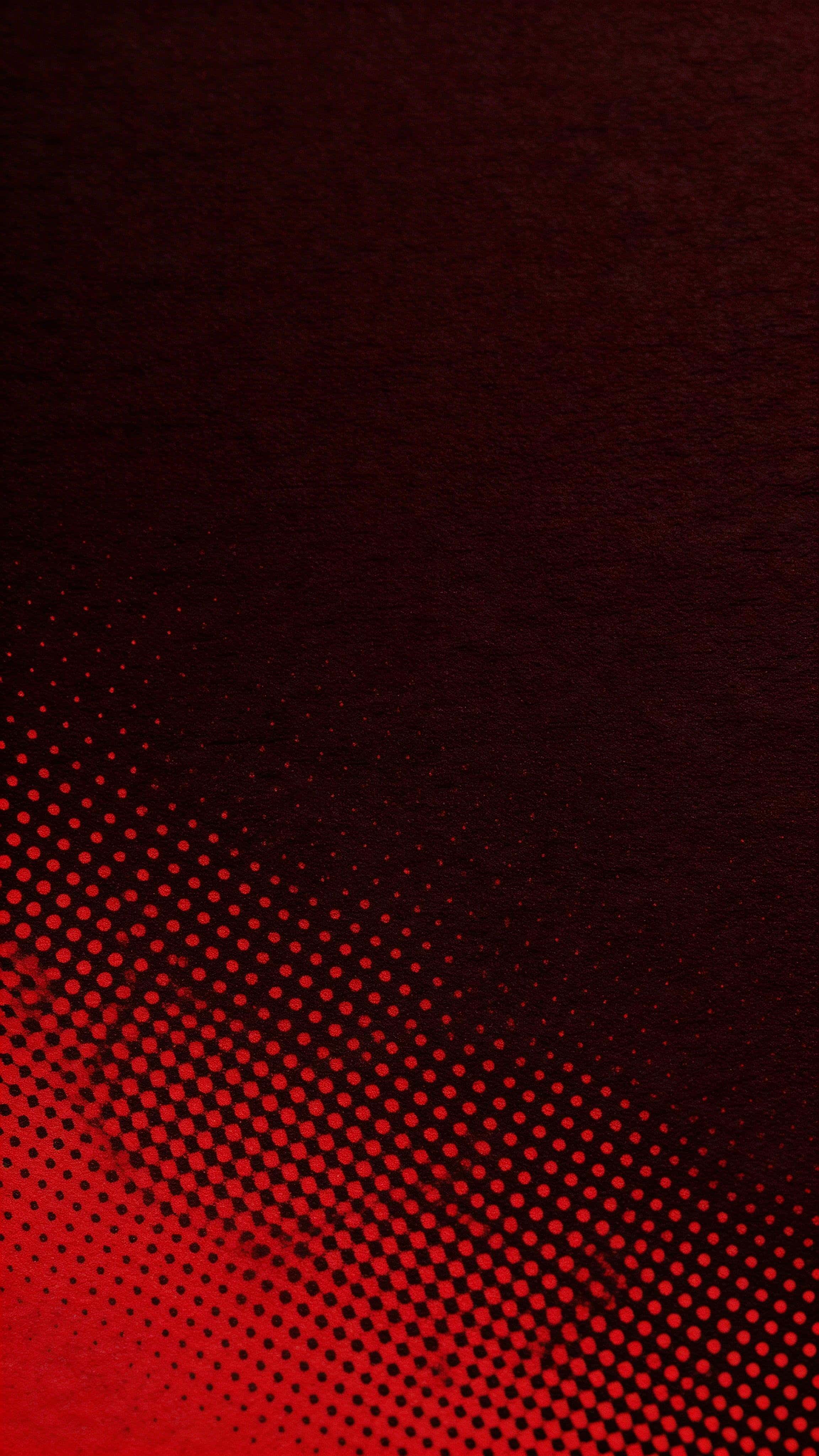 Vertical 9:16 wallpaper of a seamless crimson halftone field rising from dense, off-center dots into a calm dark top plate, with subtle ink spread and paper grain.