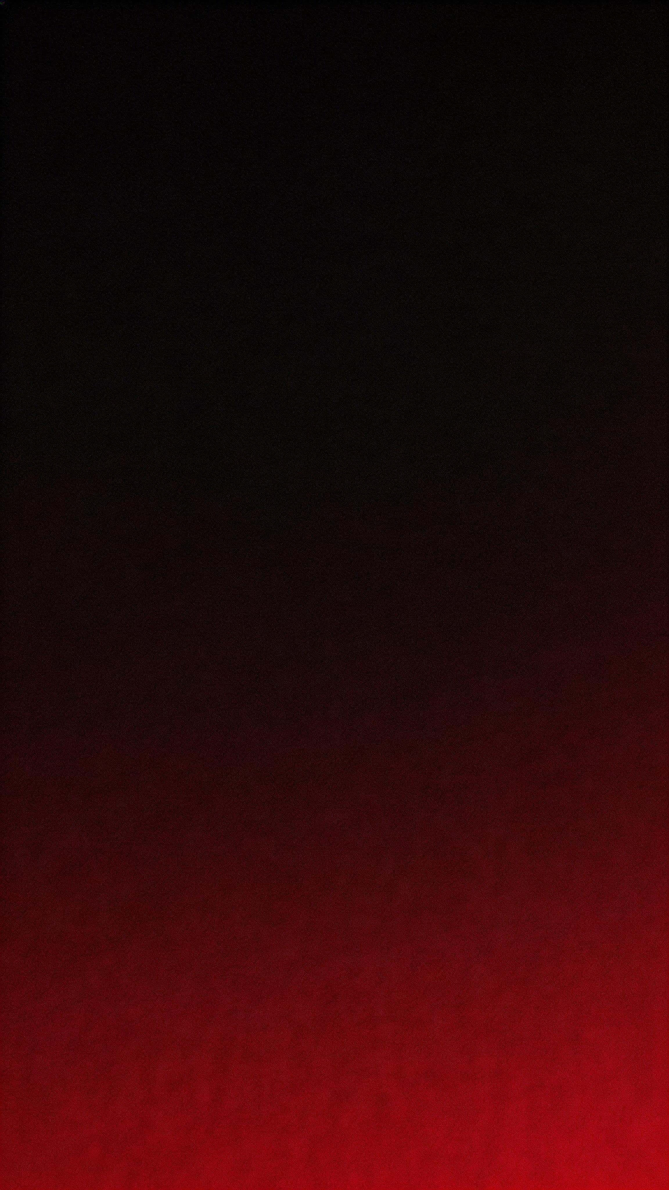 Vertical 9:16 minimalist abstract gradient wallpaper with deep crimson lifting from the lower third into near-black at the top, ultra-smooth blend, clean upper negative space, and subtle film grain.