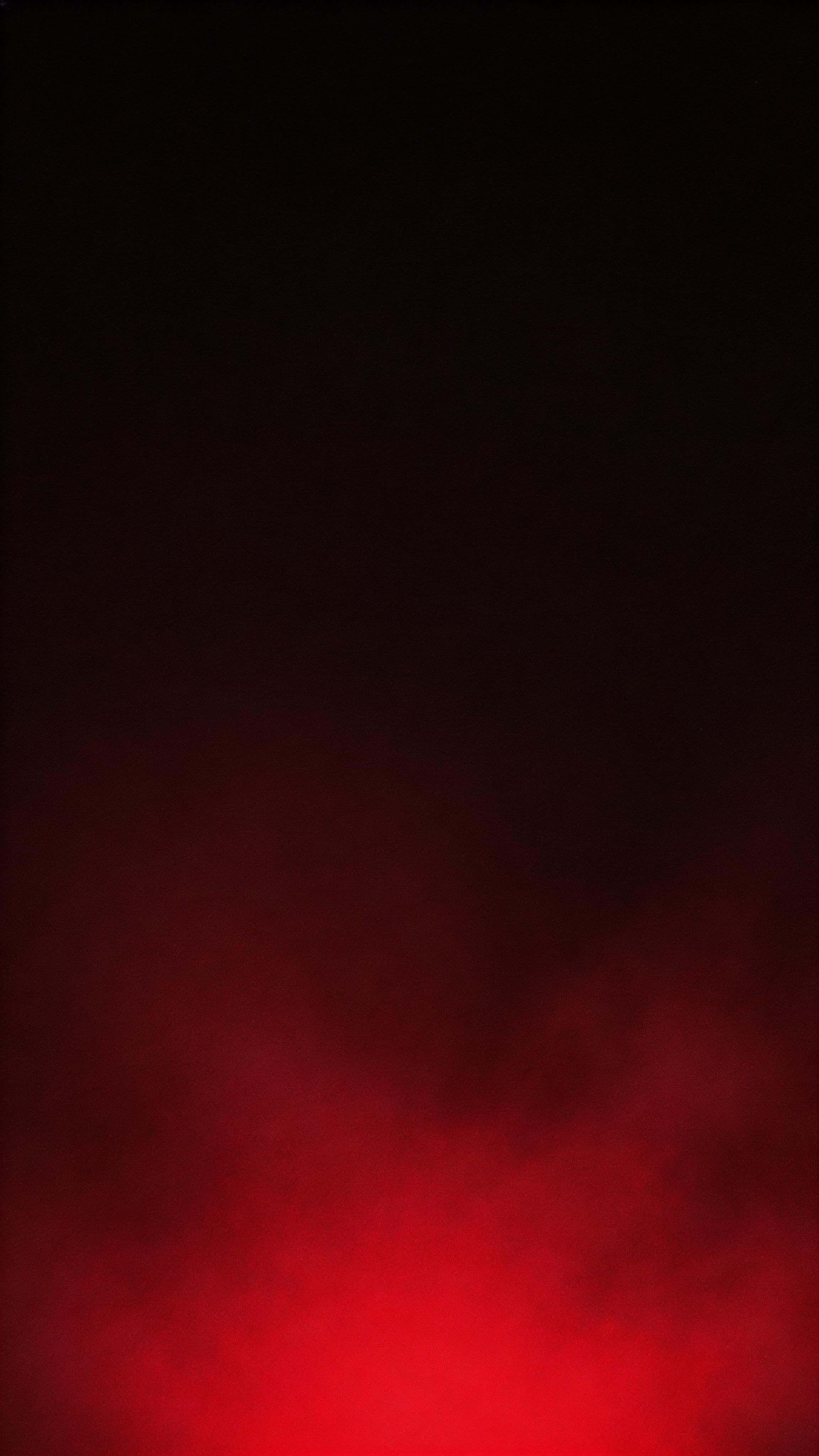 9:16 vertical wallpaper with a restrained deep crimson underglow rising from the lower third into a near-black upper field, subtle texture, and smooth fades.