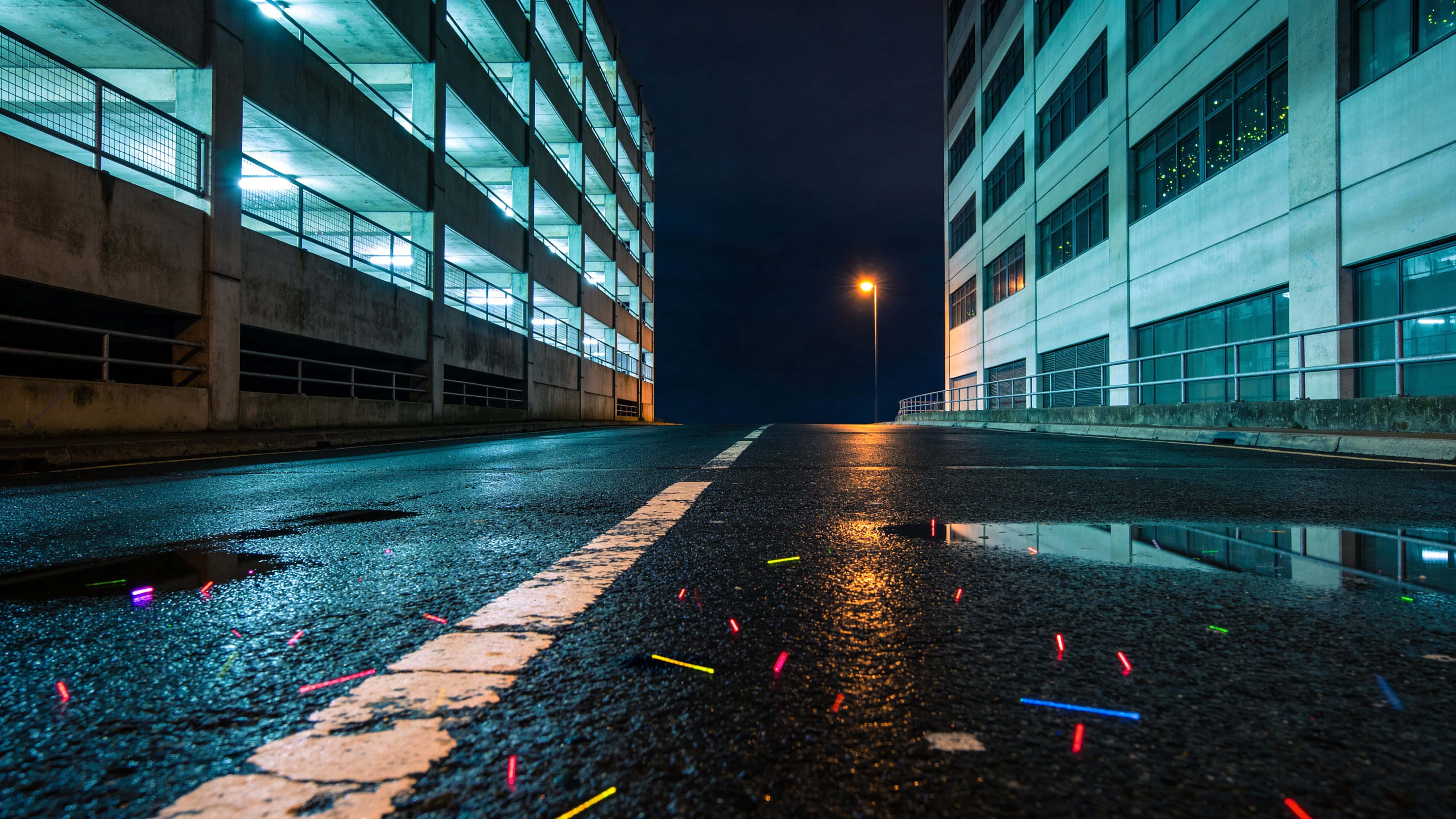 Empty street at 3 AM envisioned as a cinematic urban-night photograph for wallpaper use, framed 16:9 with wide composition, deep shadows and cool highlights.