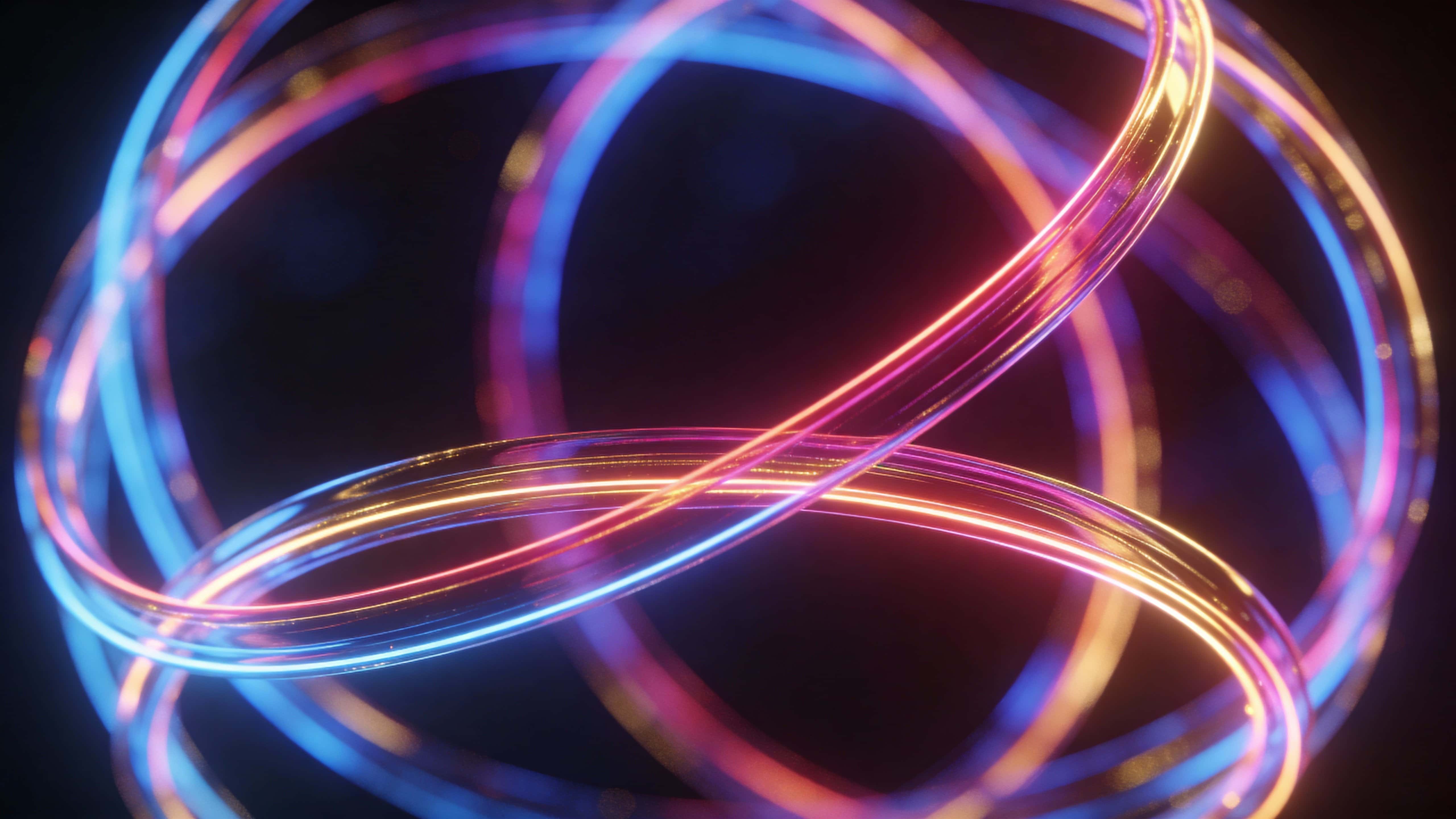 Intertwined glowing light loops form a loose spherical shape of neon lines shifting from cool blue to warm magenta and gold over a softly lit dark background.