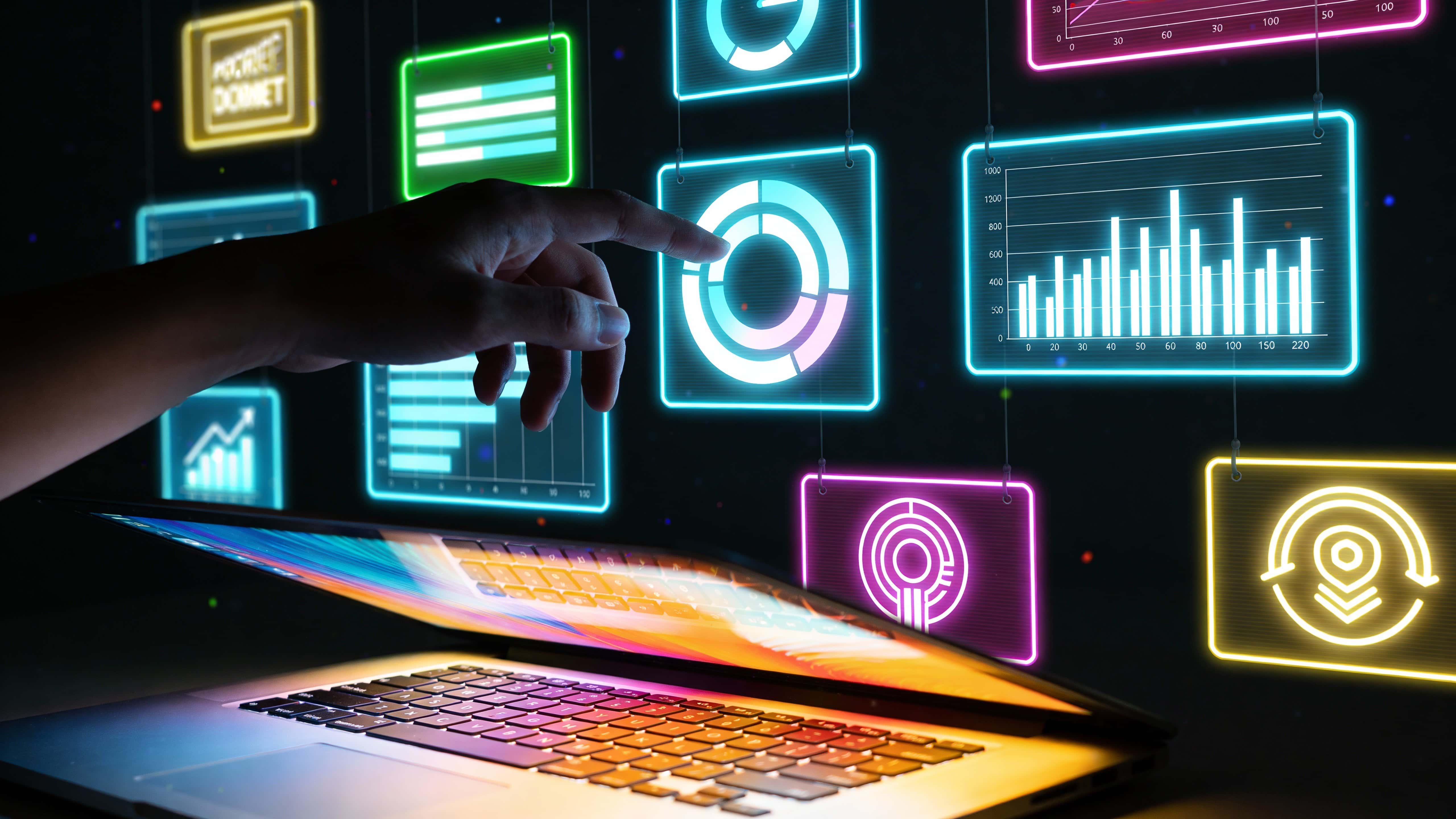 A pair of hands reaches toward a holographic wall of neon ad panels and data charts suspended above a laptop in a dim futuristic room, with glowing reflections on the keyboard and a nearly black background for contrast.