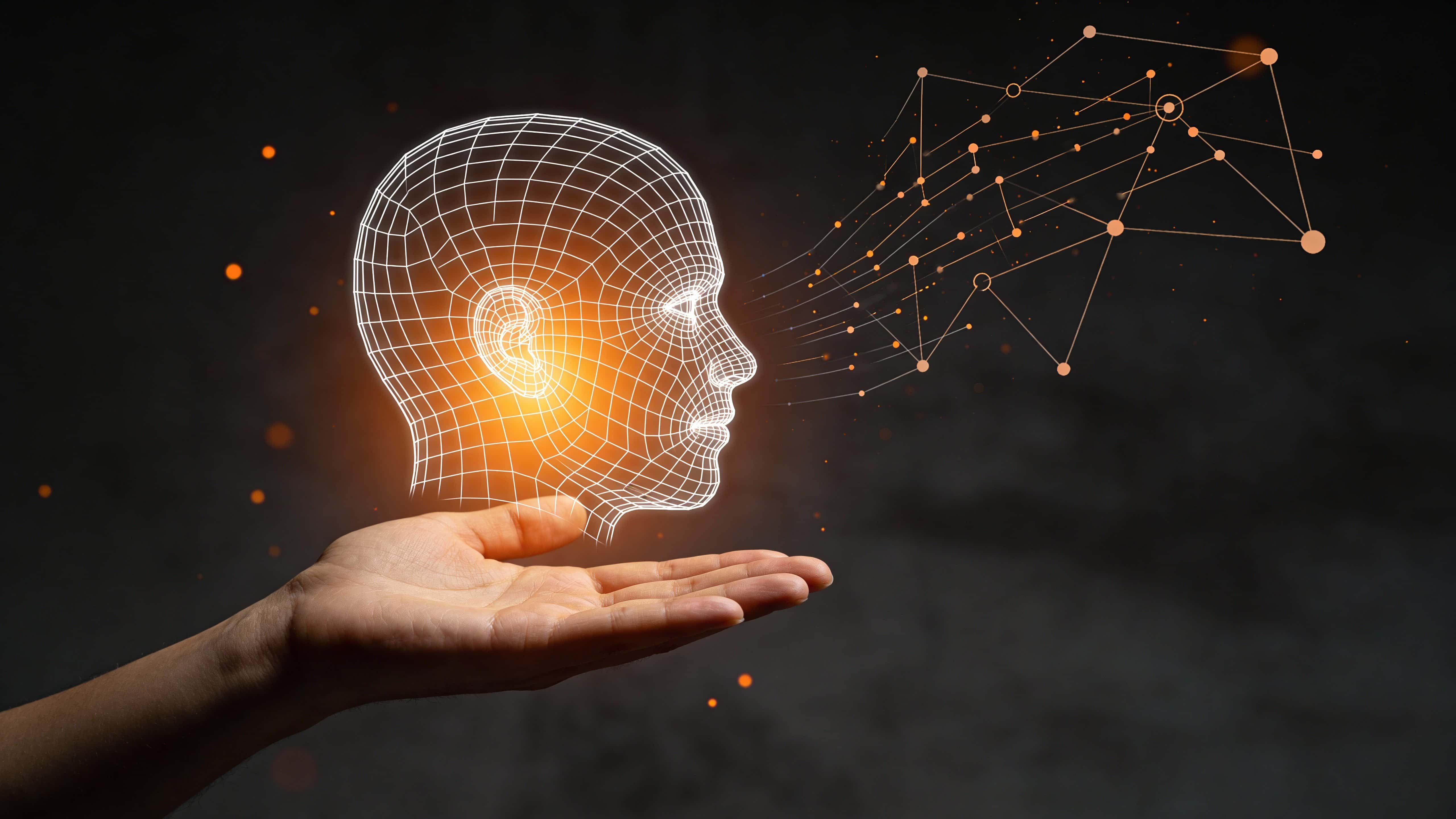 A palm-up human hand in deep charcoal space presents a glowing white wireframe half-head emerging from warm orange light with floating data nodes and particles.