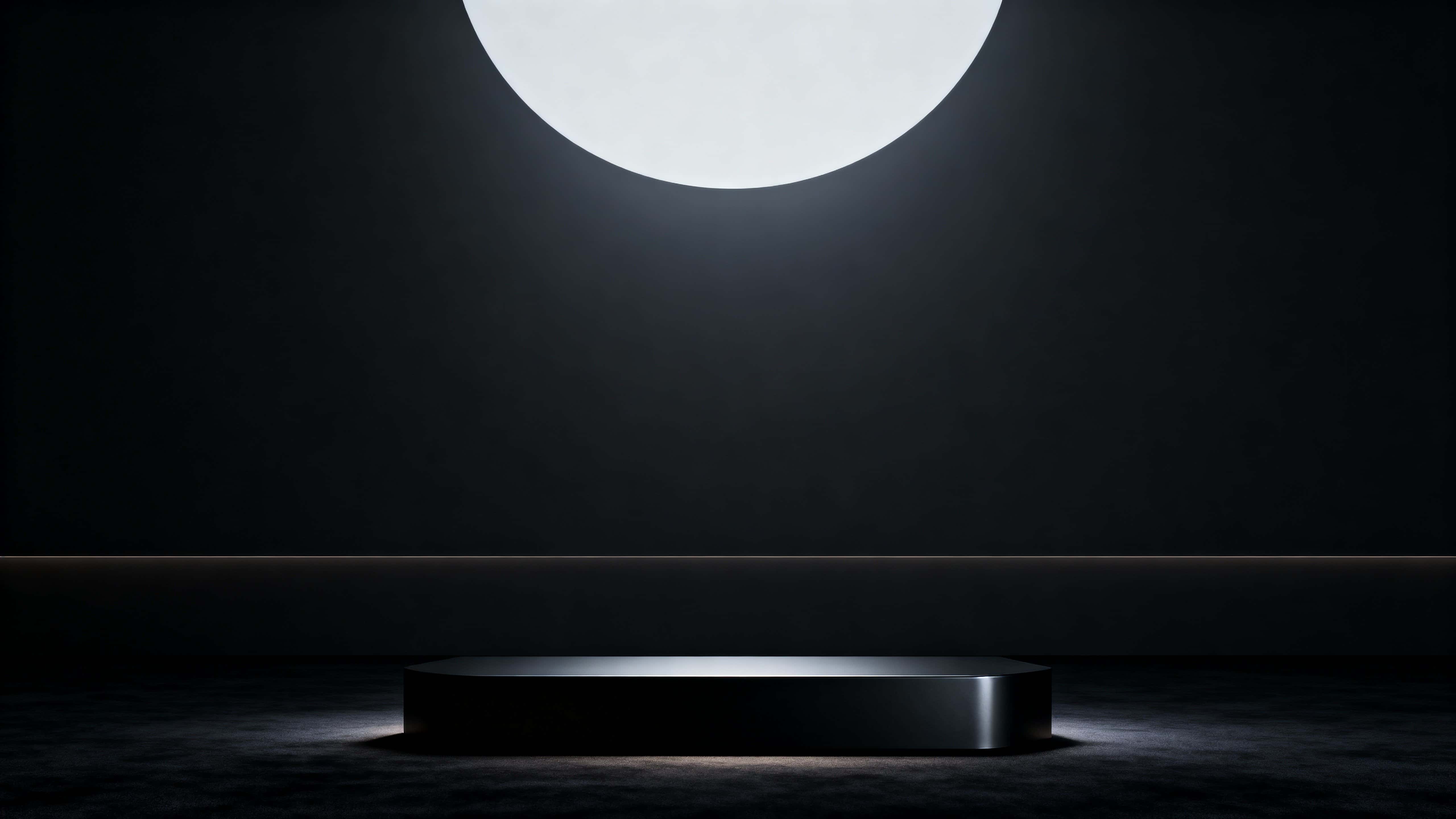 Widescreen 16:9 hero-banner 3D render of a centered low matte-black podium on a velvety near-black floor with soft top-down illumination, a subtle central vignette, and empty upper space.