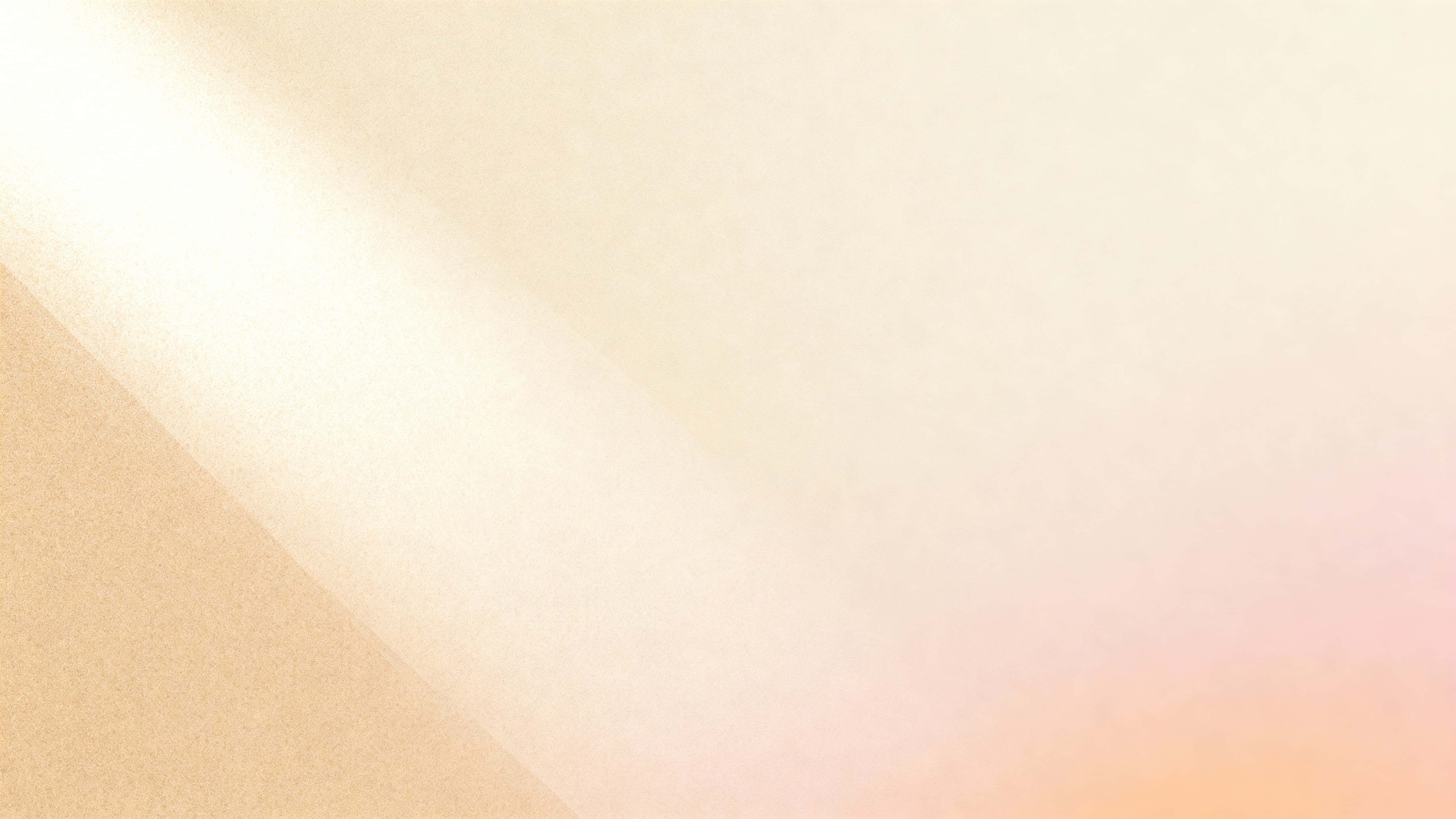 A seamless matte panel fills a 16:9 frame with a diagonal, ultra-smooth blend from warm sand through beige-rose to creamy ivory, brighter at upper-left and slightly warmer at lower-right.
