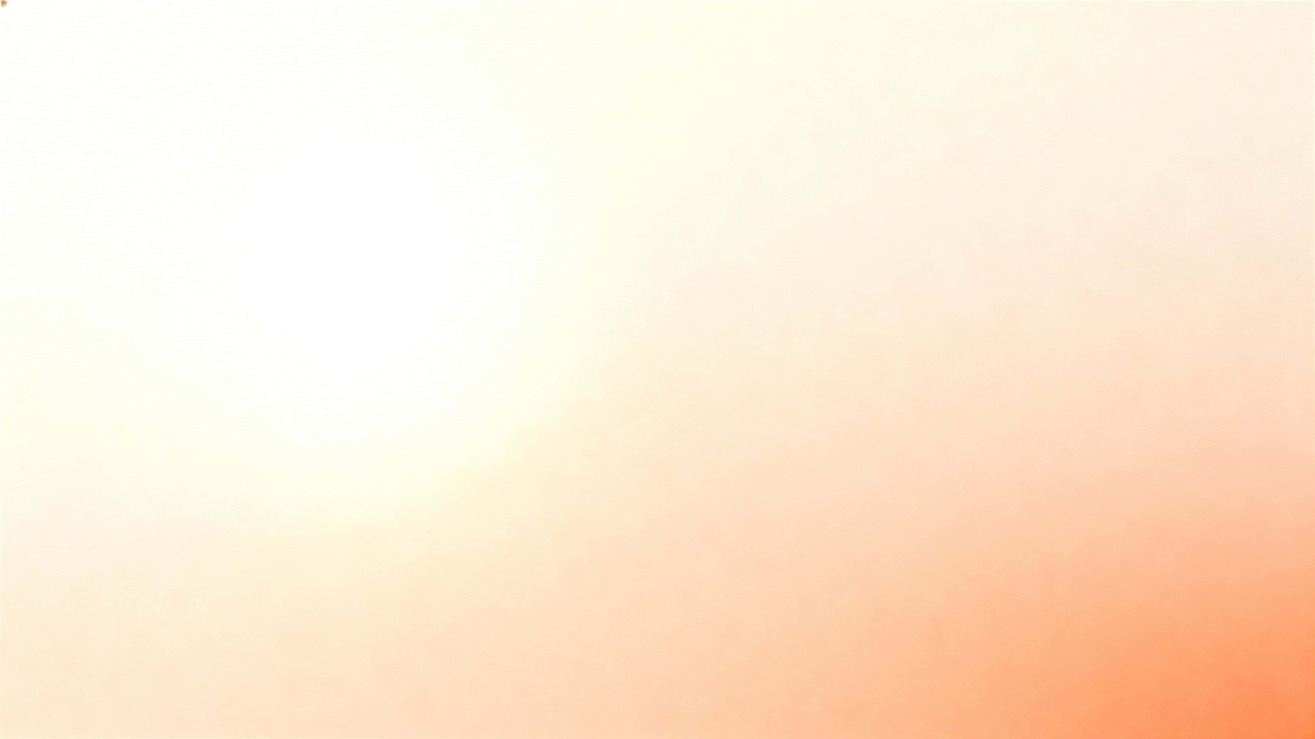 A 16:9 matte wall fills the frame with a seamless vertical gradient from light cream and soft peach at the top to apricot and pale coral below, subtly brighter above-left and warmer lower-right.