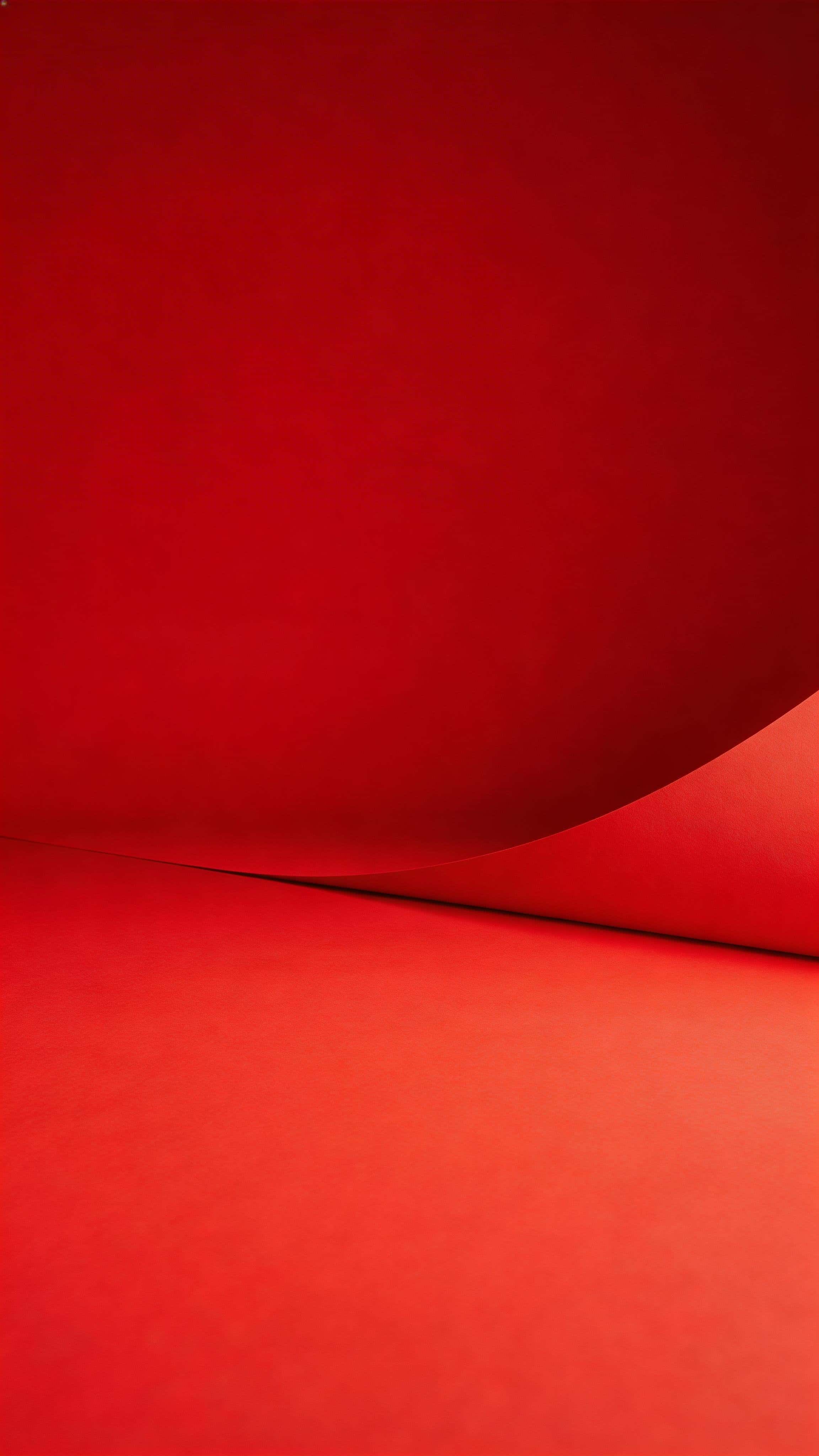 Vertical 9:16 studio product shot of a matte red seamless paper sweep with a smooth curve and soft diffusion, brightest zone in the lower half and a darker, uncluttered upper third for breathing room.