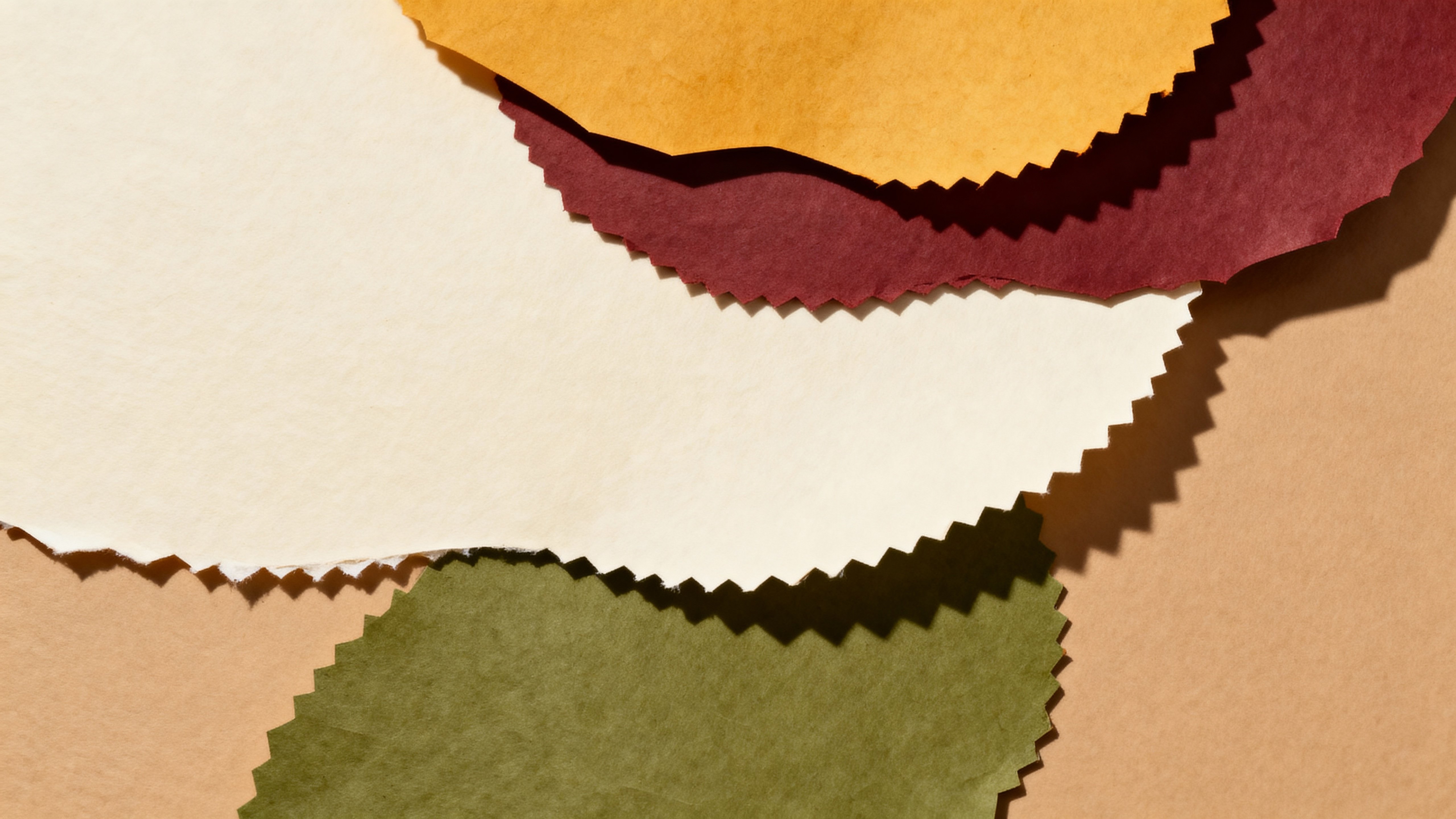 Layered paper-cut collage in an autumn palette uses ochre, oxblood, moss and cream on a matte board with two to three overlapping layers, soft shadows, crisp deckled edges and ample negative space for type.