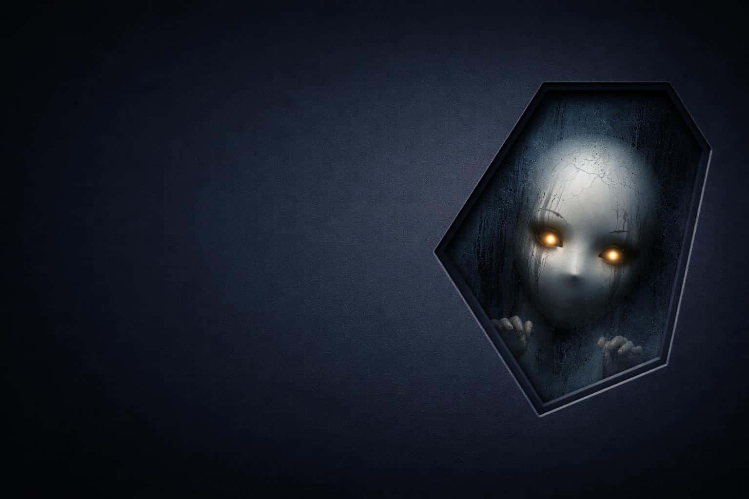 Minimal dark 3:2 desktop wallpaper showing a rounded hexagon cutout with frosted glass revealing a cracked porcelain mask and tiny glowing amber eyes behind condensation and smudges.