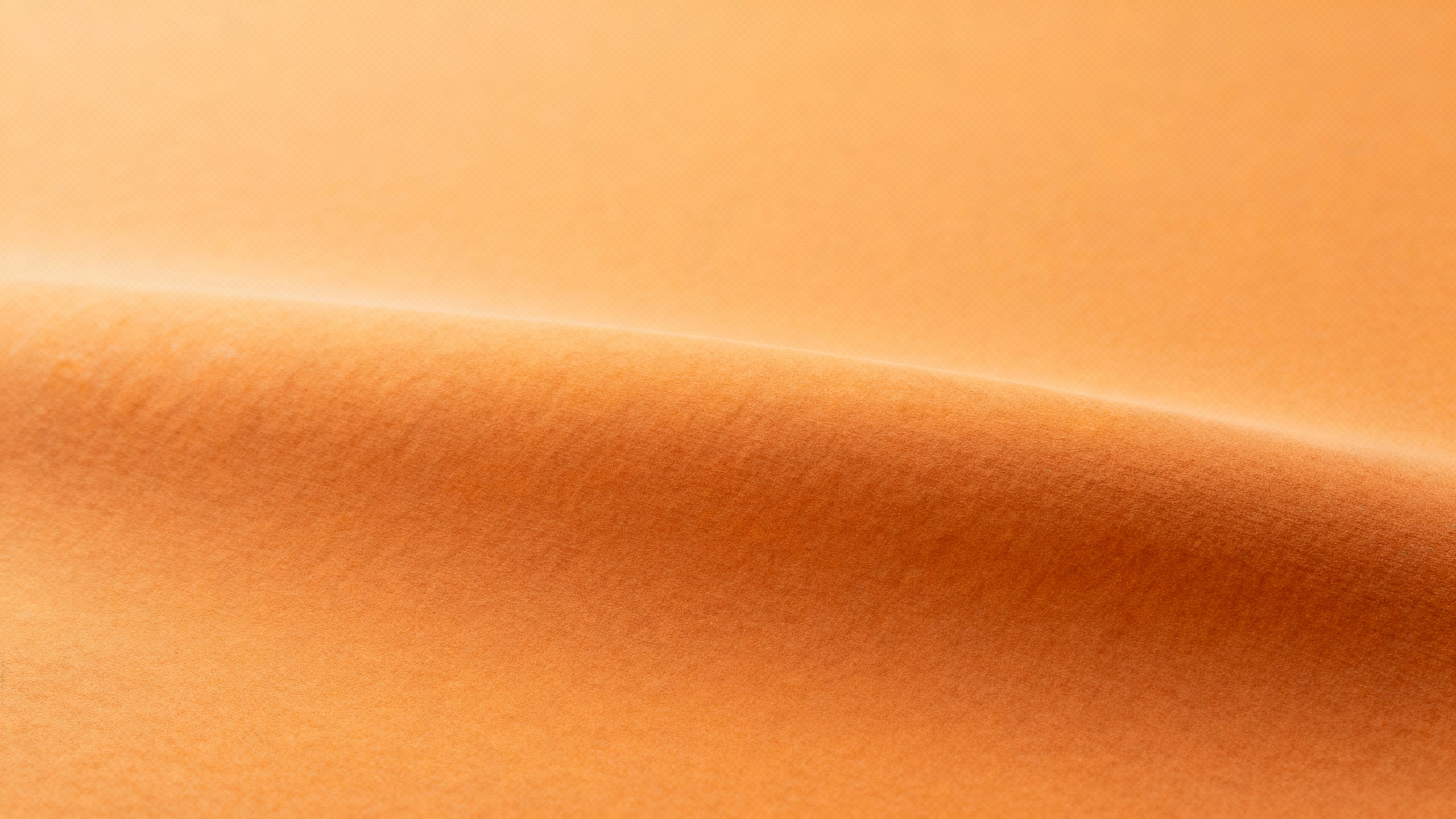 An abstract, front-on photographic color study of pumpkin tones with soft matte ochre #D99A2B, cinnamon #A84E2A and burnt orange #C25618, shallow relief and clean edges for copy space.