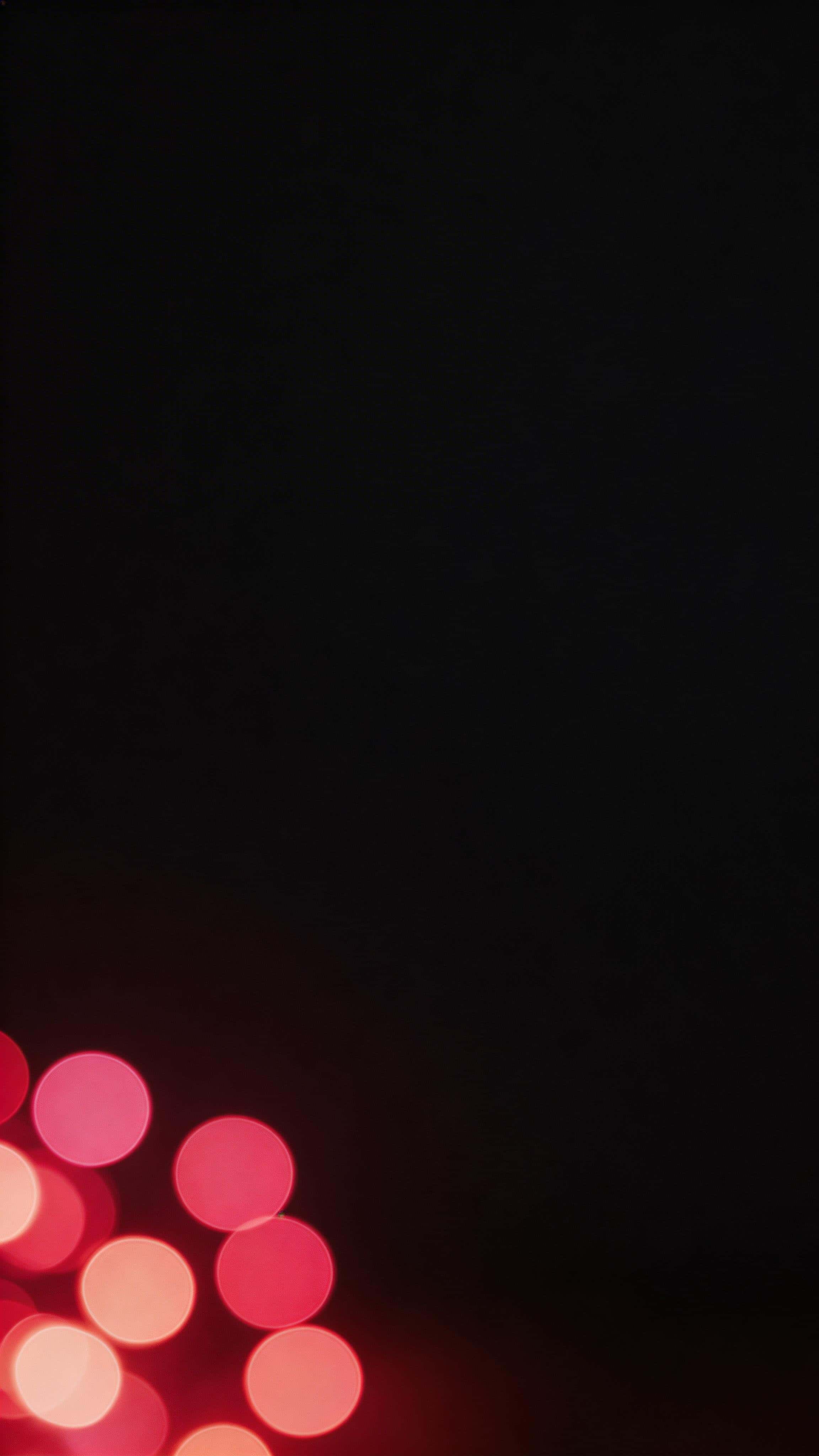 Cinematic 9:16 vertical wallpaper with soft clustered red bokeh orbs concentrated low and to one side, and a darker, uncluttered upper region left clear for icons.