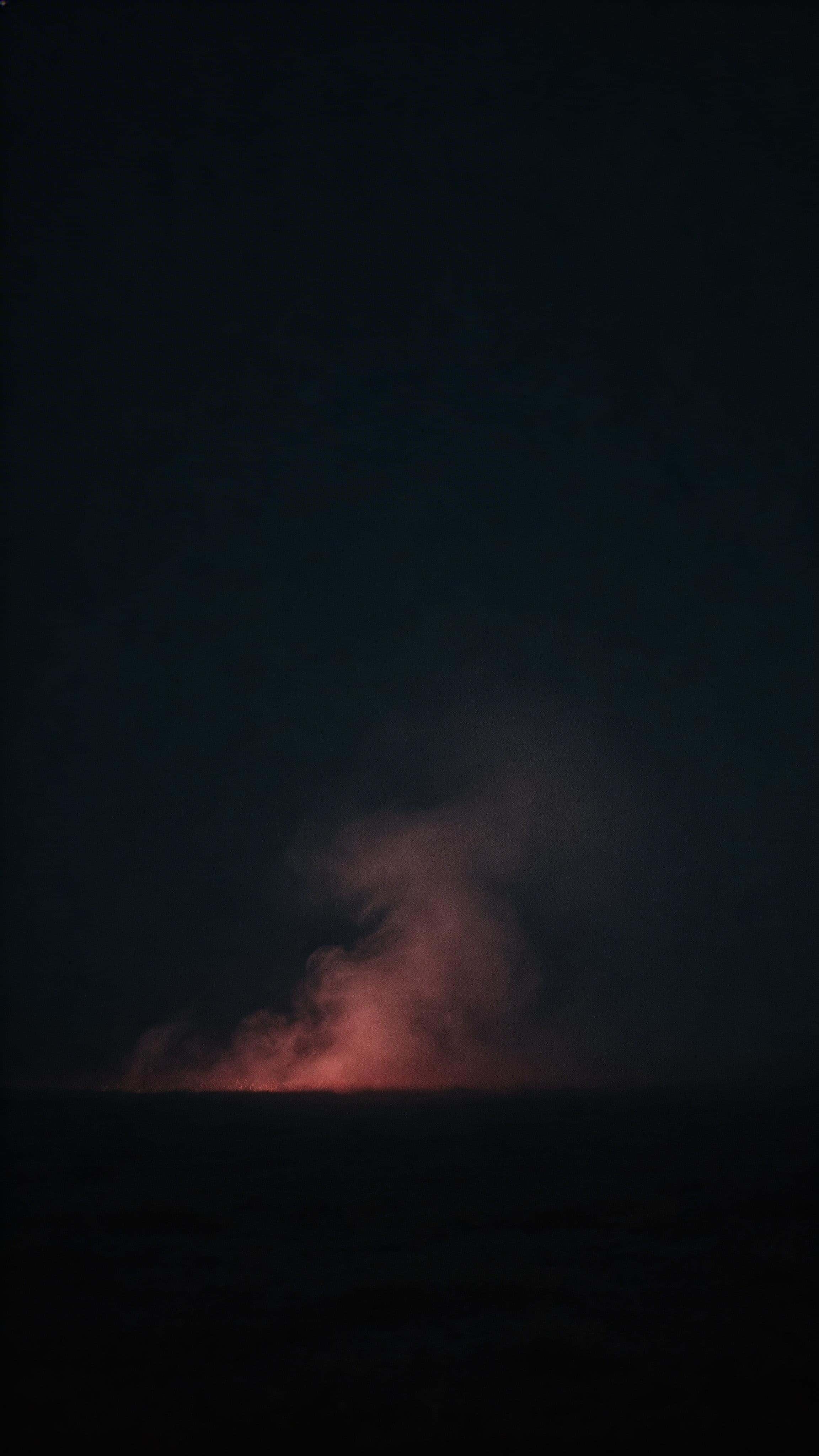 Cinematic 9:16 editorial photograph of subtle red gel-lit fog drifting upward through a near-black field, light density focused in the lower-middle with a clean darker top third.