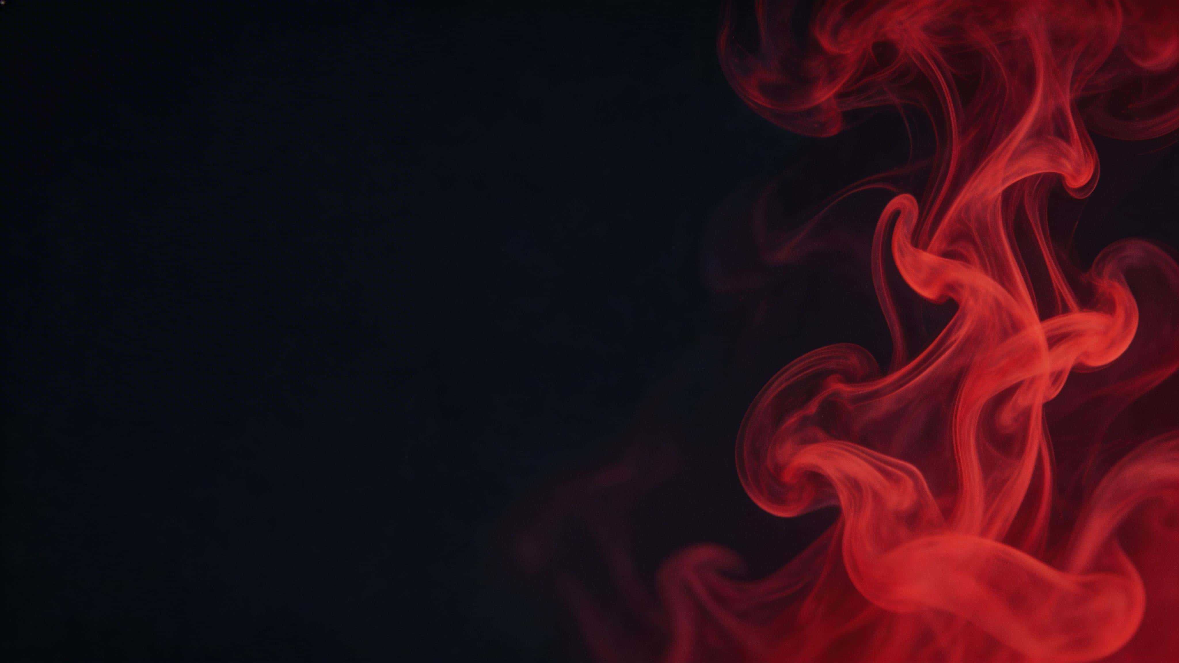 16:9 abstract fluid photograph of red ink swirling through dark liquid into marble-like ribbons and soft tendrils, with the most intricate swirl off-center and a clean darker region for negative space.