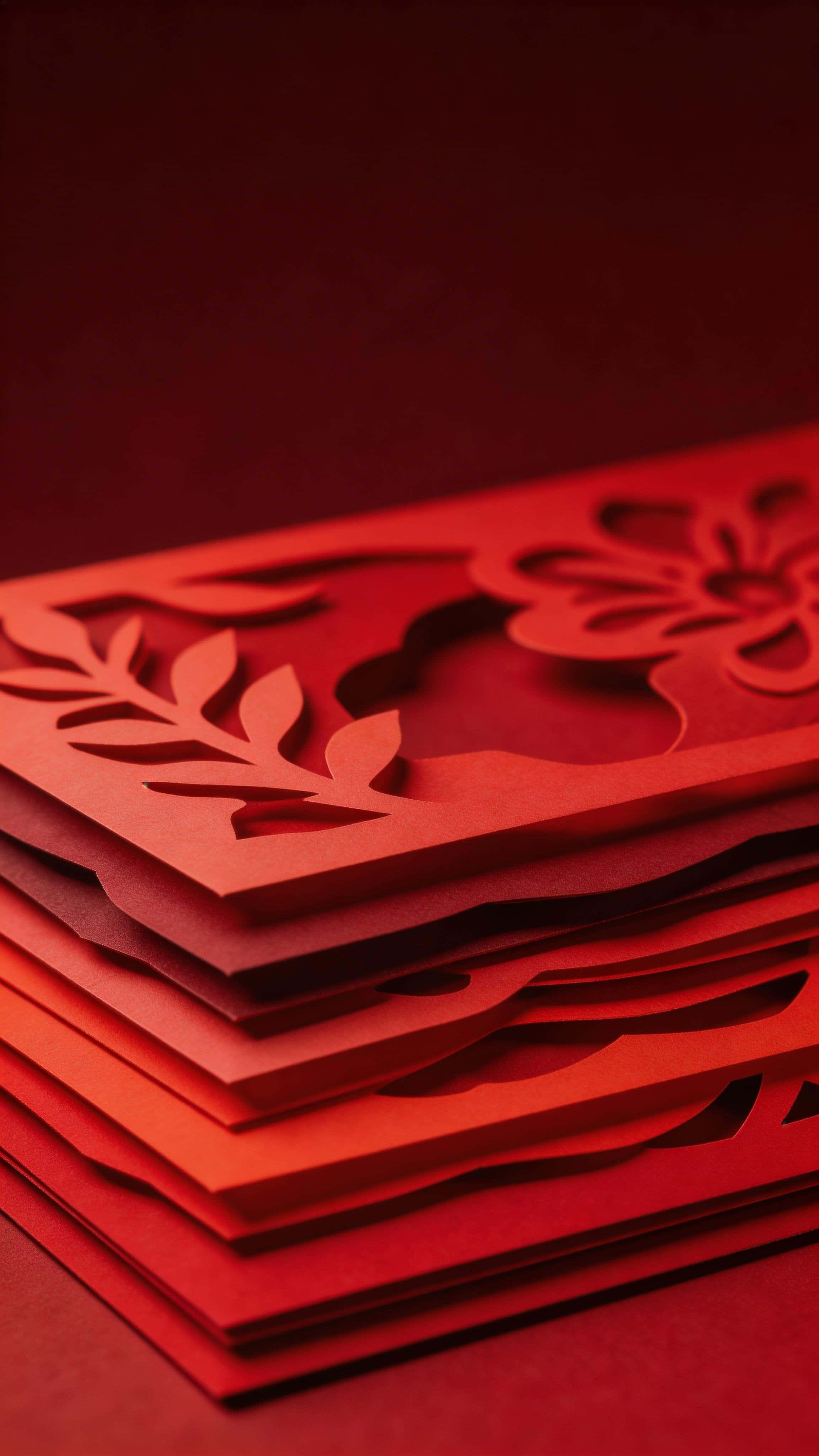 Vertical 9:16 paper-cut layered relief showing stacked red paper shapes with shallow depth and crisp contours, denser detail in the lower half and a clean, darker upper third, no text.