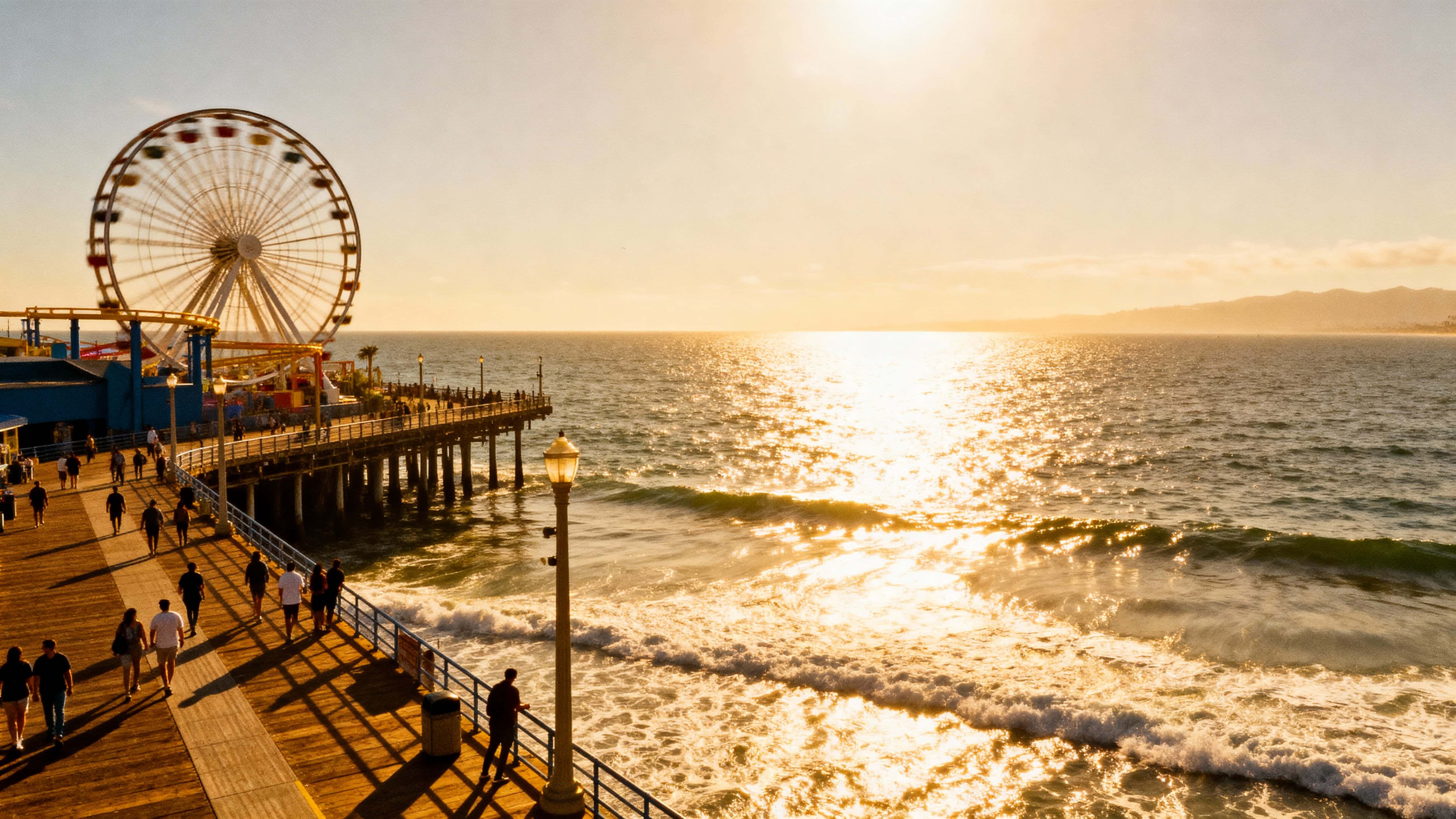 Vivid, realistic summer view of Santa Monica Pier with a spinning ferris wheel and pedestrians, sunlight sparkling off the ocean, framed in a wide 16:9 horizontal crop with the pier centered and horizon low.