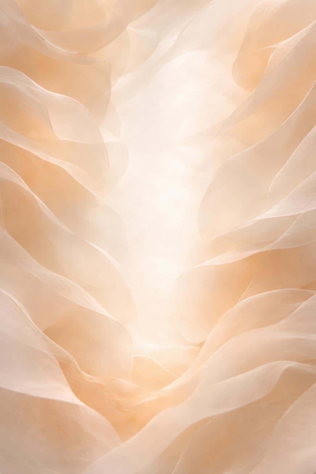 Portrait 2:3 macro of layered translucent vellum drifting upward like rose petals in cream, pale peach, and champagne with a soft, high-key, text-friendly central wash.