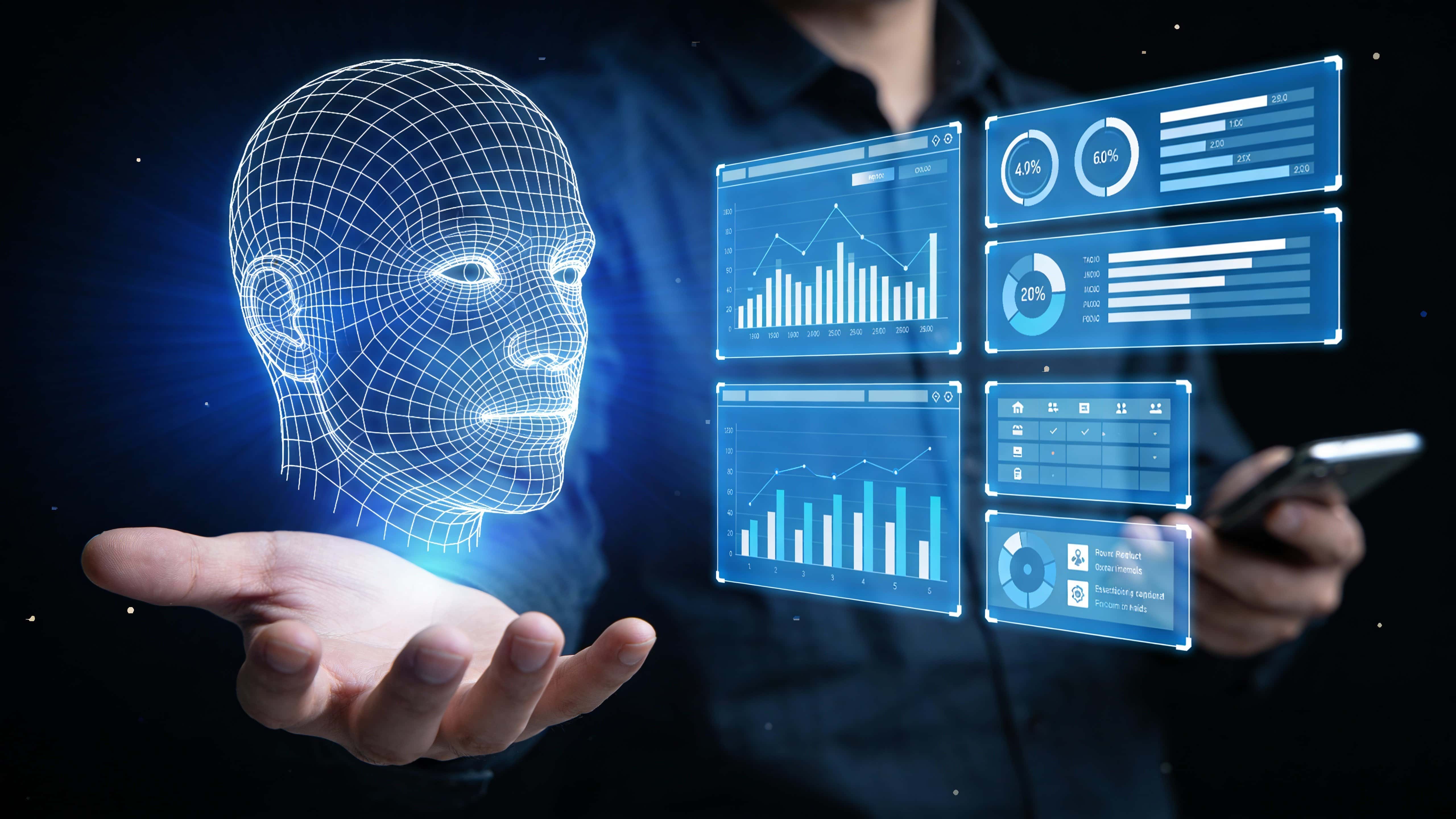 A wireframe human-face hologram hovers above an outstretched hand in a dark 16:9 scene, casting deep blue and indigo light onto floating data panels and a blurred smartphone.